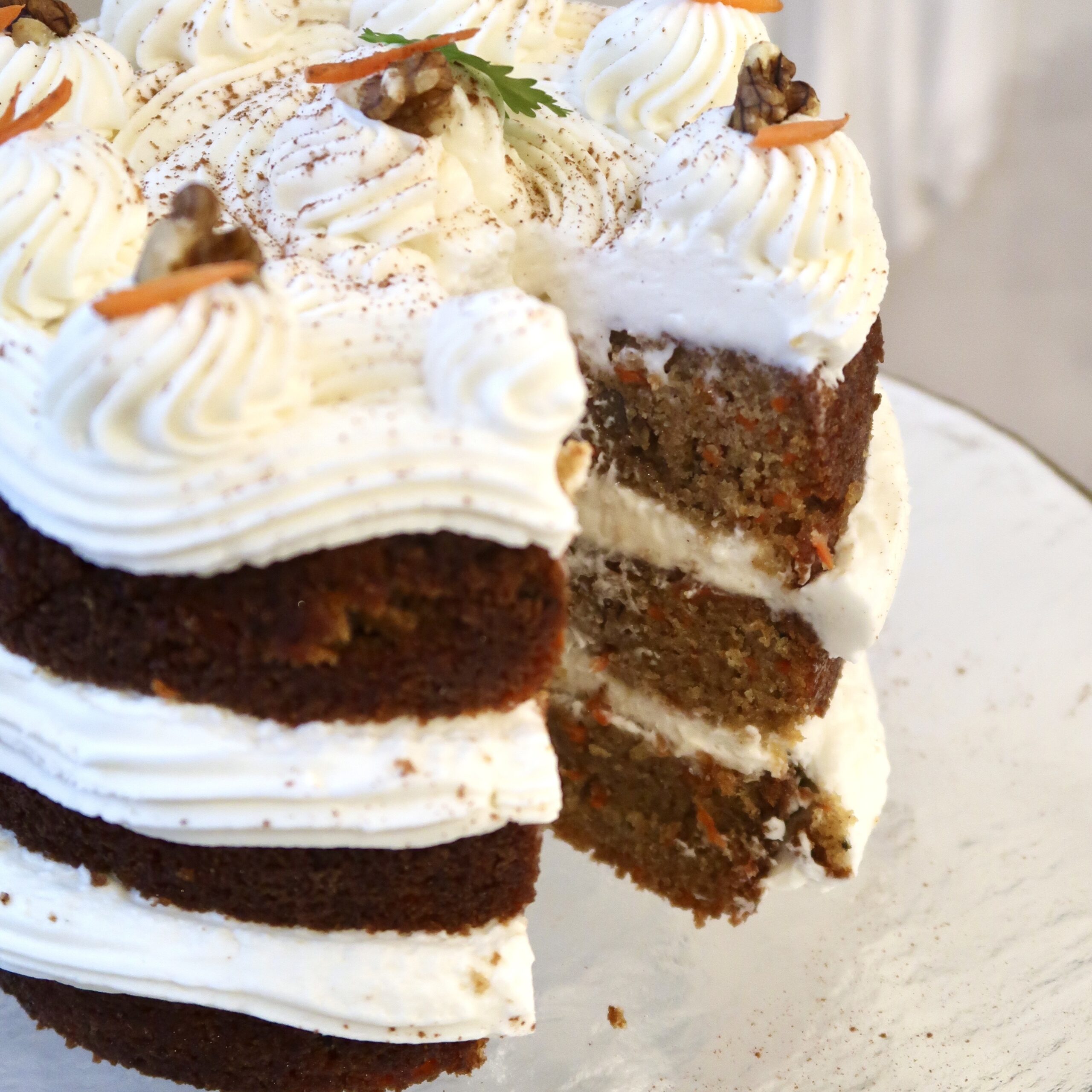 Whisking cream cheese, butter, powdered sugar, and vanilla to make carrot cake frosting